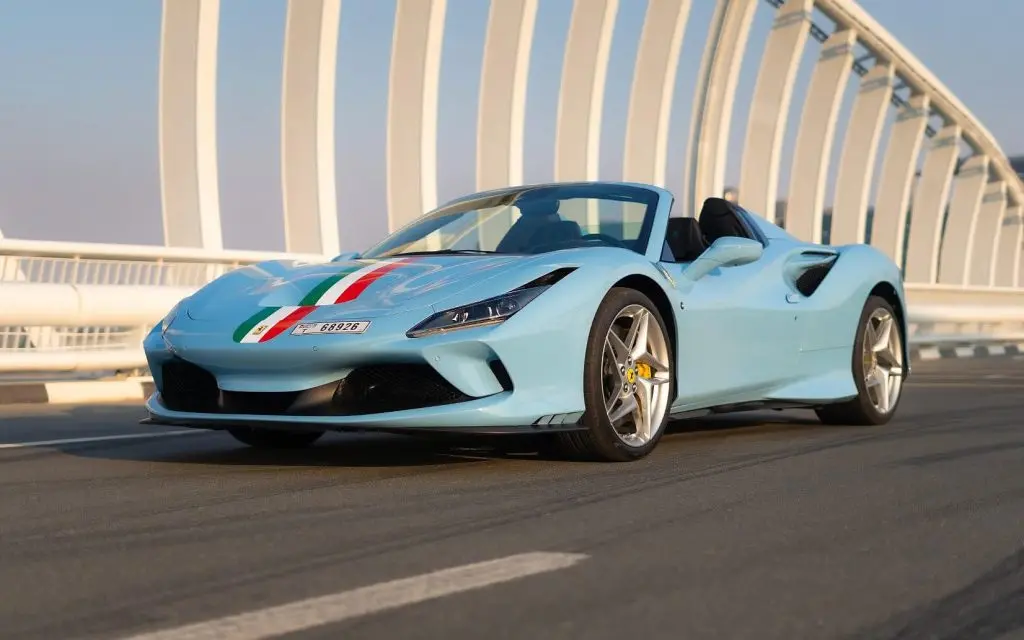 blue sports car over dubai bridge